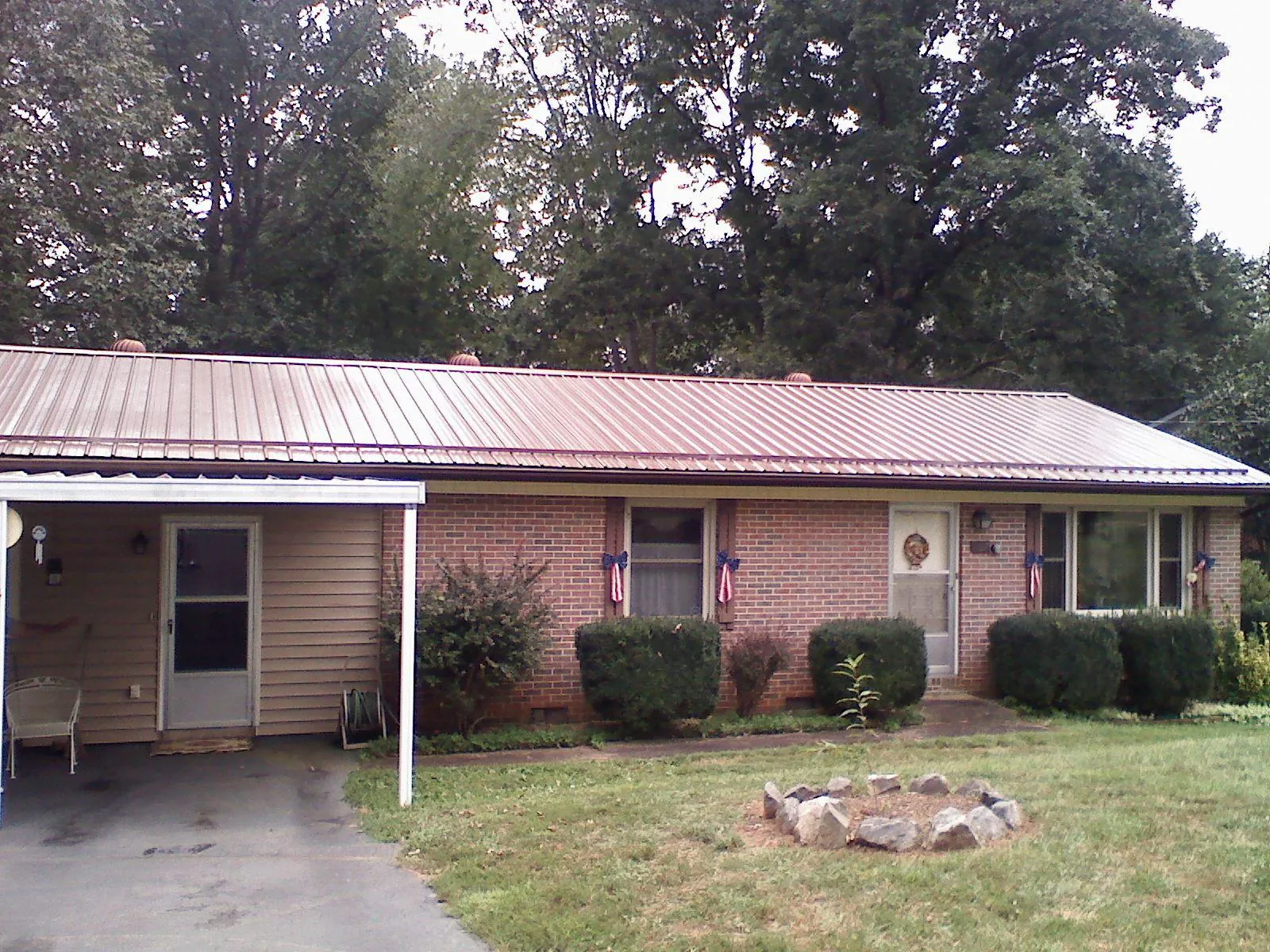 Bronze metal roof and carport on a brick ranch home — Roof Repair work by our crew in Eastsound